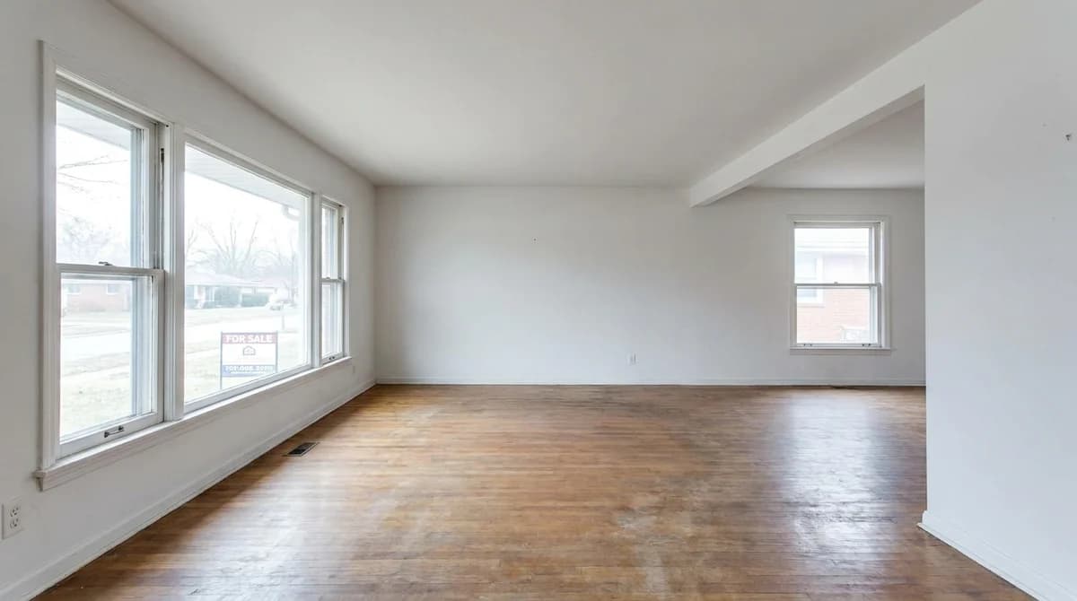 Empty unfurnished living room in a vacant home before staging